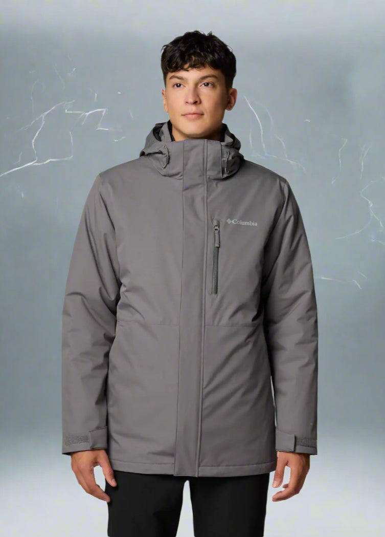 Person wearing a gray jacket with a brand logo on a white background